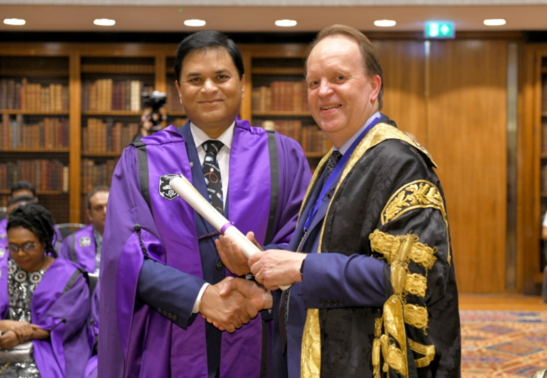 Dr. Noel Deep, MD, receives his Royal College of Physicians (RCP) fellowship scroll from Dr. John Dean, Clinical Vice-President of the RCP.